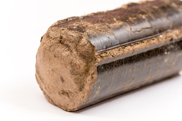 Brown pressed wood briquettes over white background