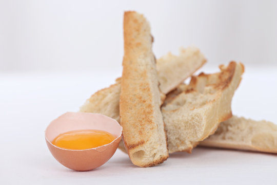 close up of an egg shell and toasted bread slices