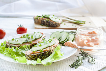 Sandwiches with fish butter, cucumber and herbs in lutucce for a snack breakfast