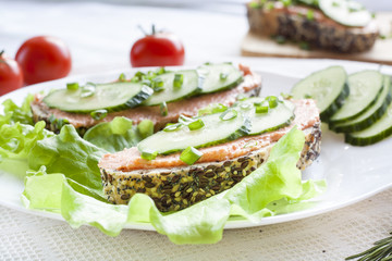 Sandwiches with fish butter, cucumber and herbs in lutucce for a snack breakfast