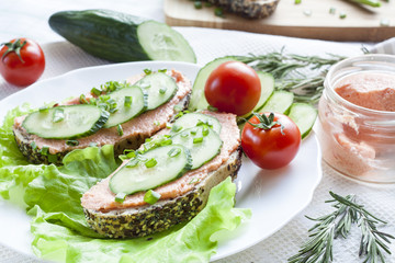 Sandwiches with fish butter, cucumber and herbs in lutucce for a snack breakfast