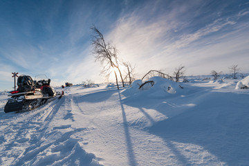 Snowmobiles On Landscape Against Sky