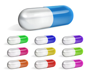 Set of multicolored oblong capsules with shadows on white background