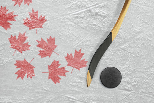 Hockey puck, hockey sticks and maple leaves