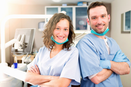 Portrait of a team of young attractive dentist in his office