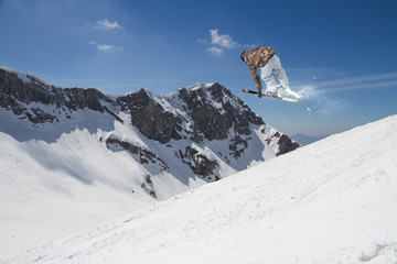 Fototapeta na wymiar Flying skier on mountains. Extreme sport.