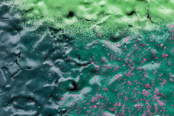 Macro close-up of colourful spray paints on a wall.