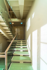 Glass and wooden stairs in modern home interior 