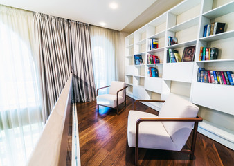 Home library with arm chair.