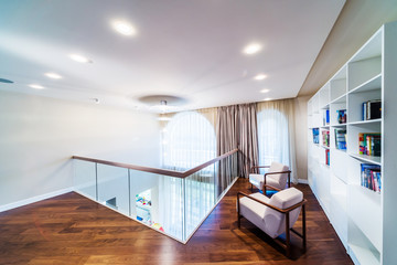 Home library with arm chair.