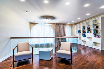 Home library with arm chair.