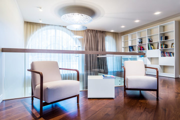 Fototapeta premium Home library with arm chair.