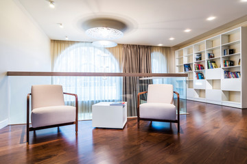 Fototapeta premium Home library with arm chair.