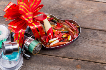 gift fishing tsckles with red and gold bow