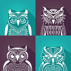 a set of plane graphic portraits of owls. vector illustration