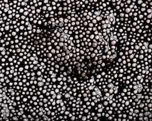 Colorful background - textured black wet Plasticine background