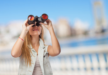 beautiful young woman looking through binoculars