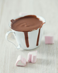 hot chocolate and heart-shaped marshmallow on wooden table