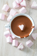 hot chocolate and heart-shaped marshmallow on wooden table