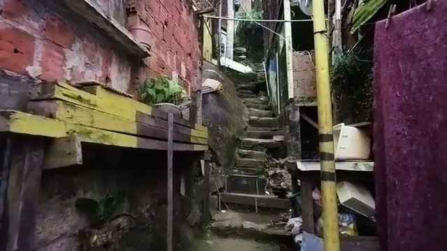 Tracking shot of crowded shanties along the stairs in a favela in Rio de Janeiro, Brazil