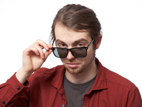 Young man looking disparaging over the sunglasses