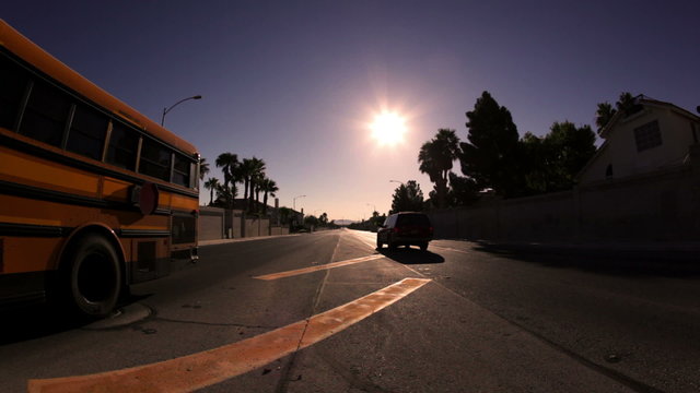 Static shot of a street with a car and a bus.