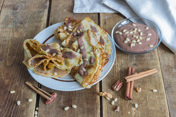 sweet pancakes with walnuts, topped with chocolate sauce