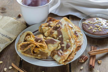 sweet pancakes with walnuts, topped with chocolate sauce