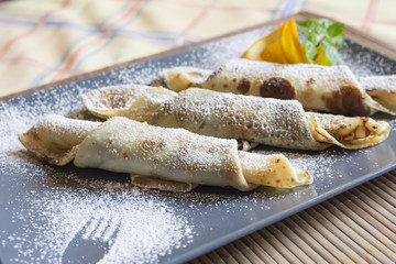 Delicious pancakes with powdered sugar