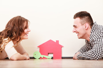 Couple with paper house. Housing real estate.