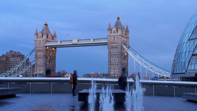 View of the iconic Tower bridge in London with a jet of water in the foreground