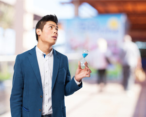 chinese man holding sand-timer