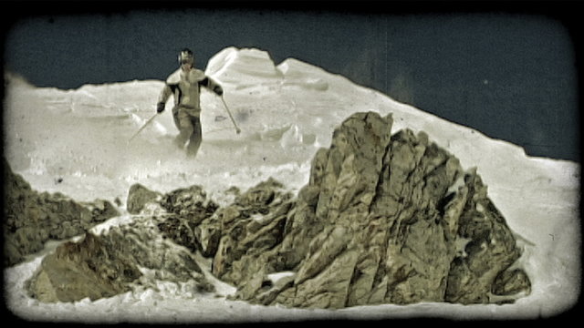 Man skis over ridge jump. Vintage stylized video clip.