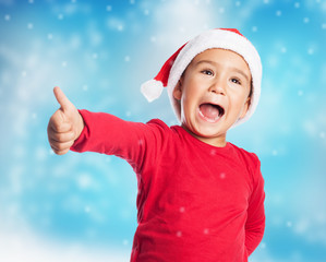 portrait of a little boy on christmas time with thumb up