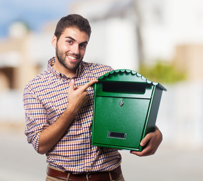 A handsome young man holding a malbox