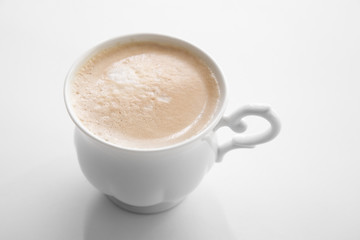 Latte coffee in vintage cup on background