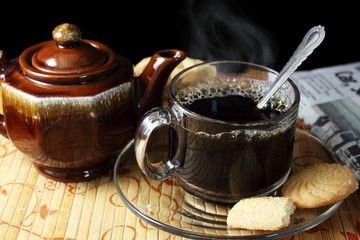 coffee cup with steam and biscuits or cookies closeup
