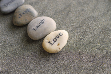 Pebbles printed with words love, dream, joy 