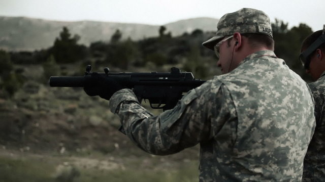 Soldier in goggles shoots an MP5