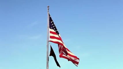 Static shot of American and POW/MIA flags flying over the Korean War Veterans Memorial