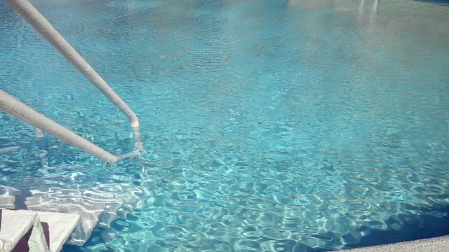 Grab bars ladder in swimming pool, outdoors at the day time
