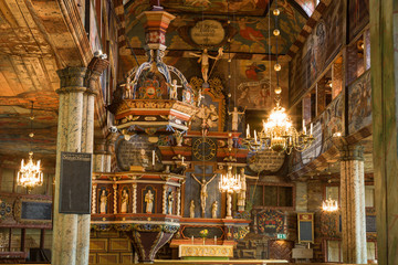 Fototapeta na wymiar Pulpit and altar piece in an old Wooden Church