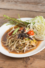 Som Tam is spicy green papaya salad, Thai food.