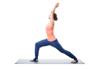 Sporty fit yogini woman practices yoga asana utthita Virabhadras