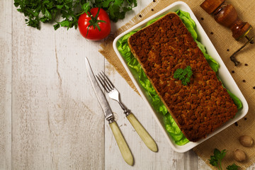 Homemade meat pie with vegetables, served with cranberry sauce