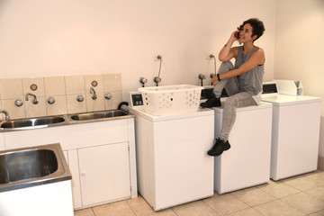 young girl waiting for the washing machine