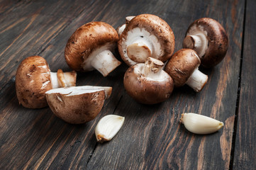 Brown mushroom on wood background, close up