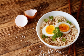 Top view on board with chinese noodles and salt around