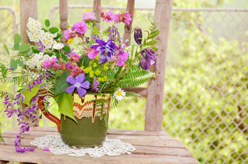 hand made vase with colorful spring wild flowers