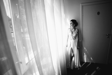 Bride posing in a large window